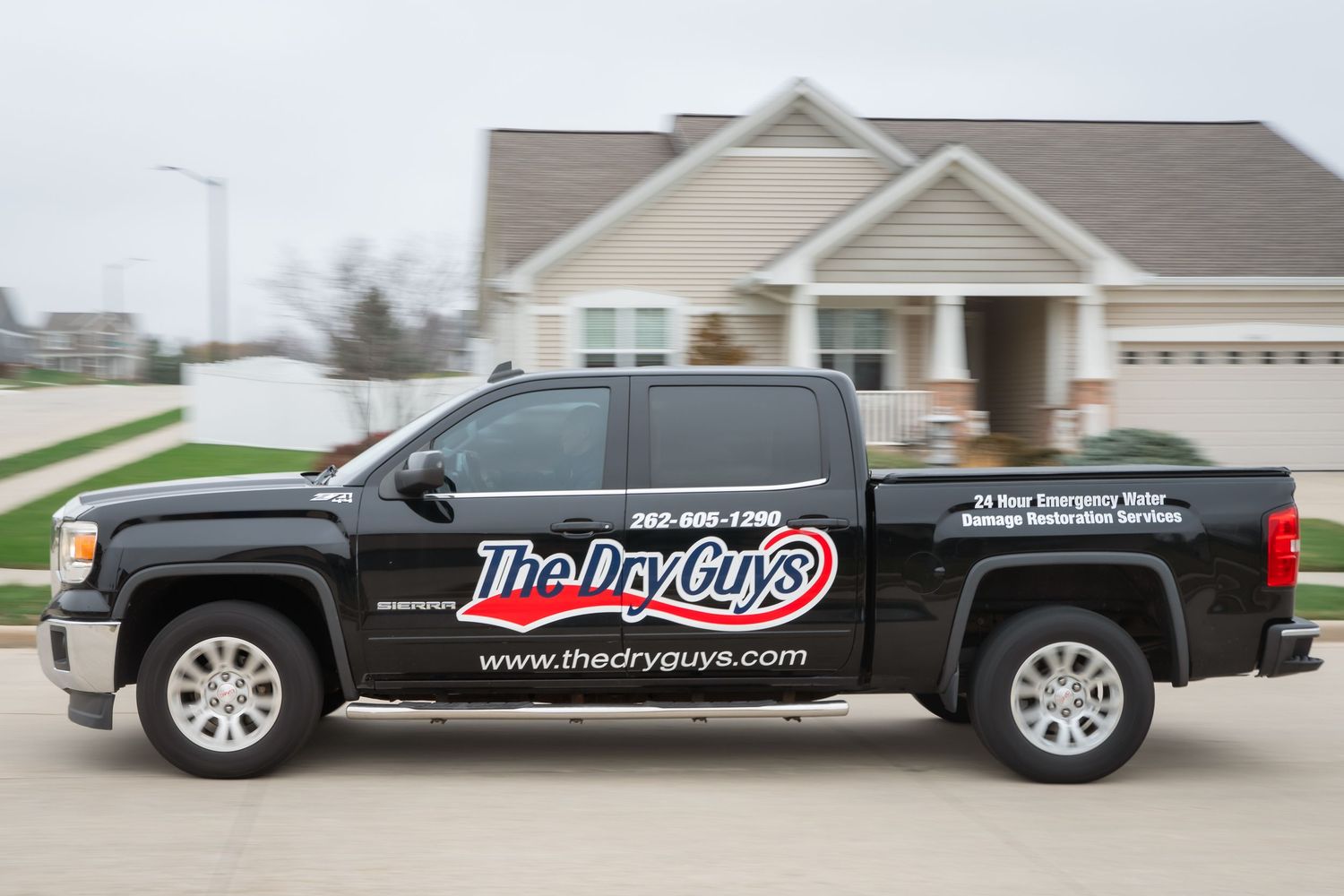 A black pickup truck with The Viper Guys business branding and phone number displayed on the side.