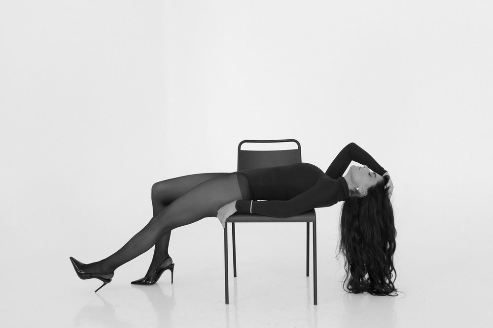 A minimalist black and white photo series showing silhouettes of figures in abstract poses against a white background.