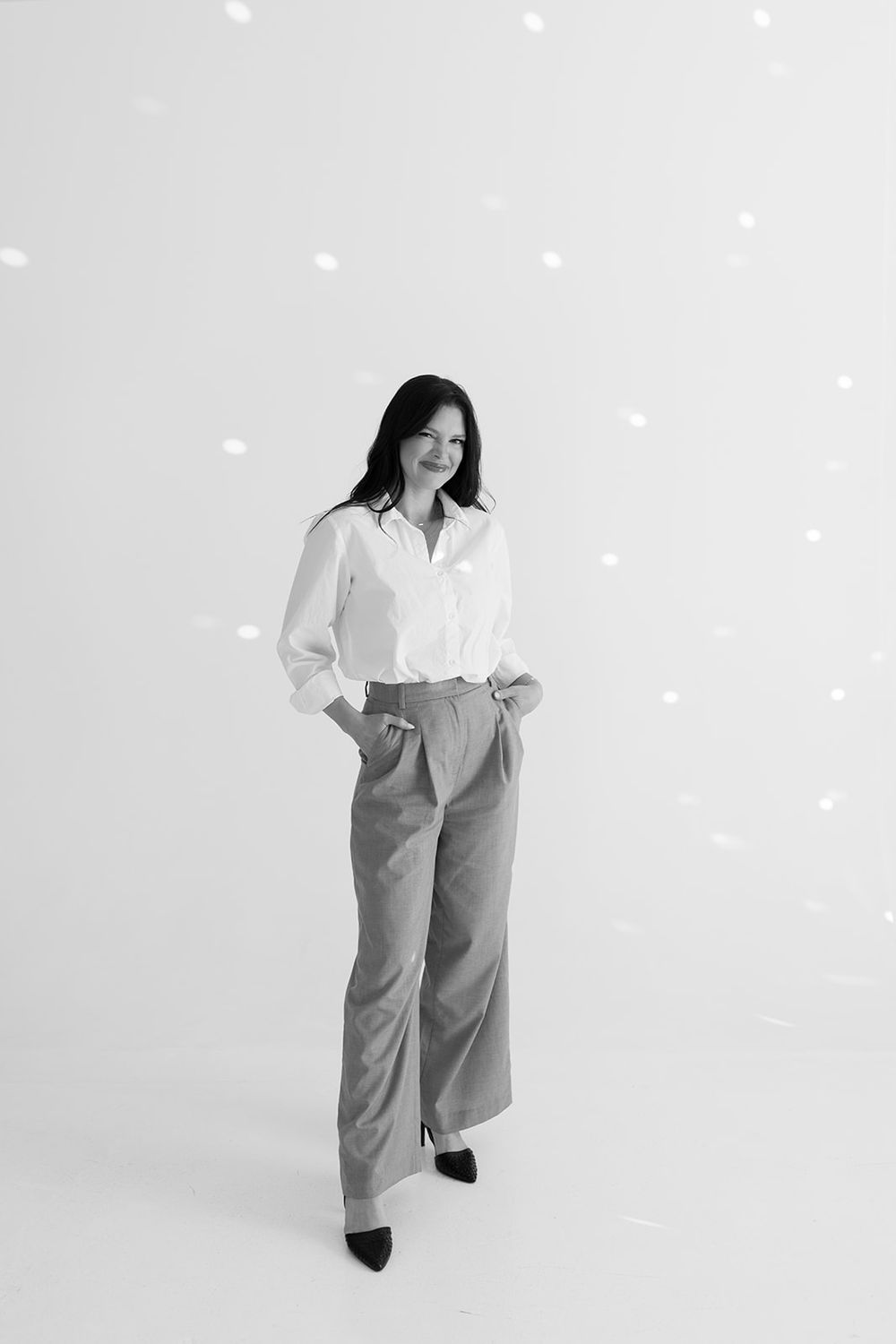 A person in a white button-down shirt and gray trousers poses against a light background in three different stances.
