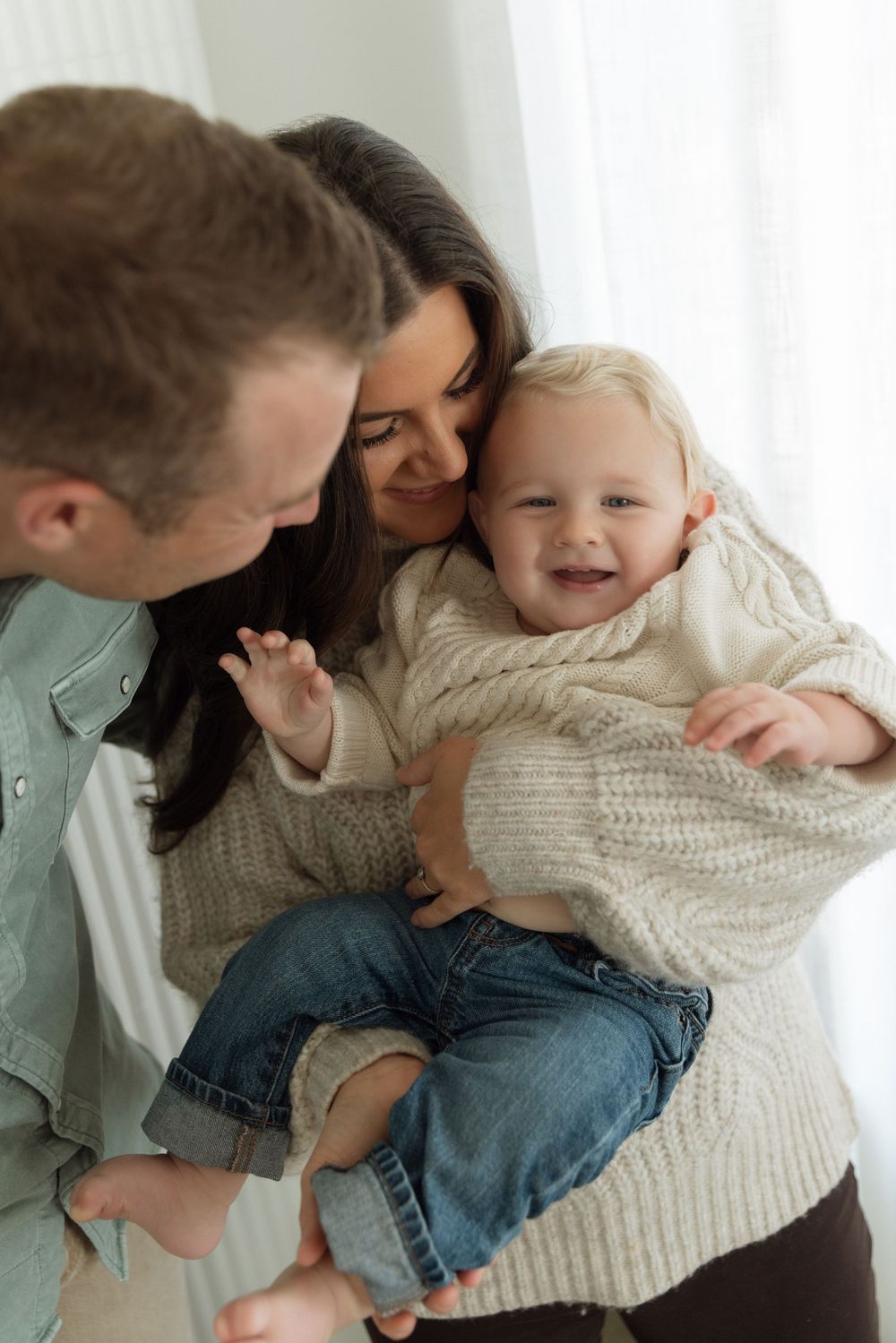 A family shares tender moments in a series of candid photographs showing playful interaction and affection.