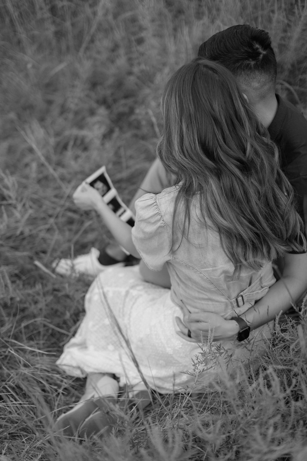 A black and white photo series shows someone lying in grass while reading a book in various relaxed positions.