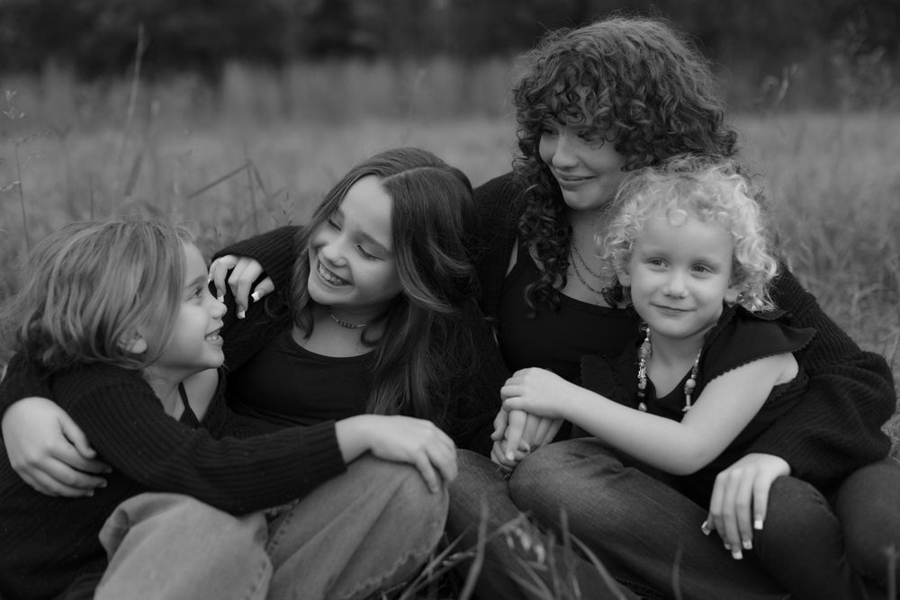 A black and white collage of candid family photos showing joyful moments and embraces.