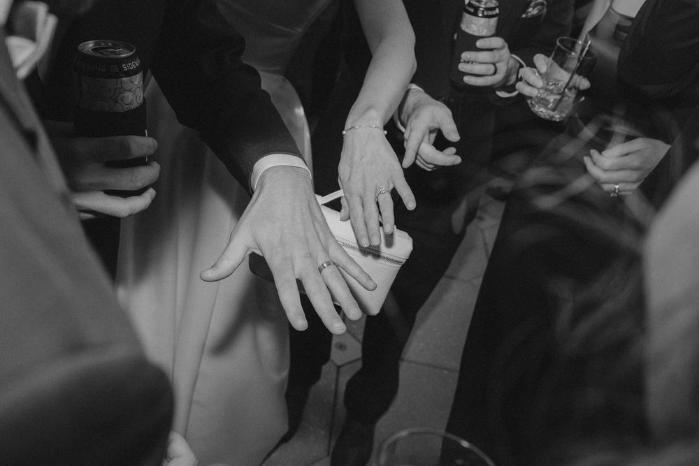 Hands of people working together to stack and arrange colorful blocks in a team building exercise.