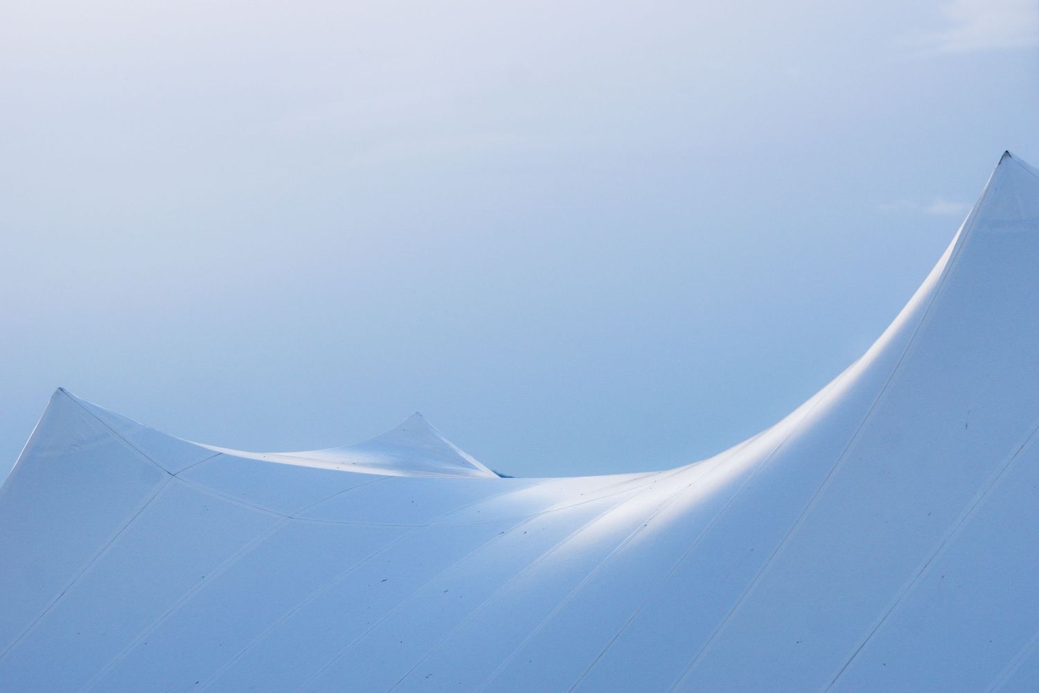 An abstract photo of a curved bluish-white shape and peaks, with soft light falling on the curve. Photo by Jessica Rix.