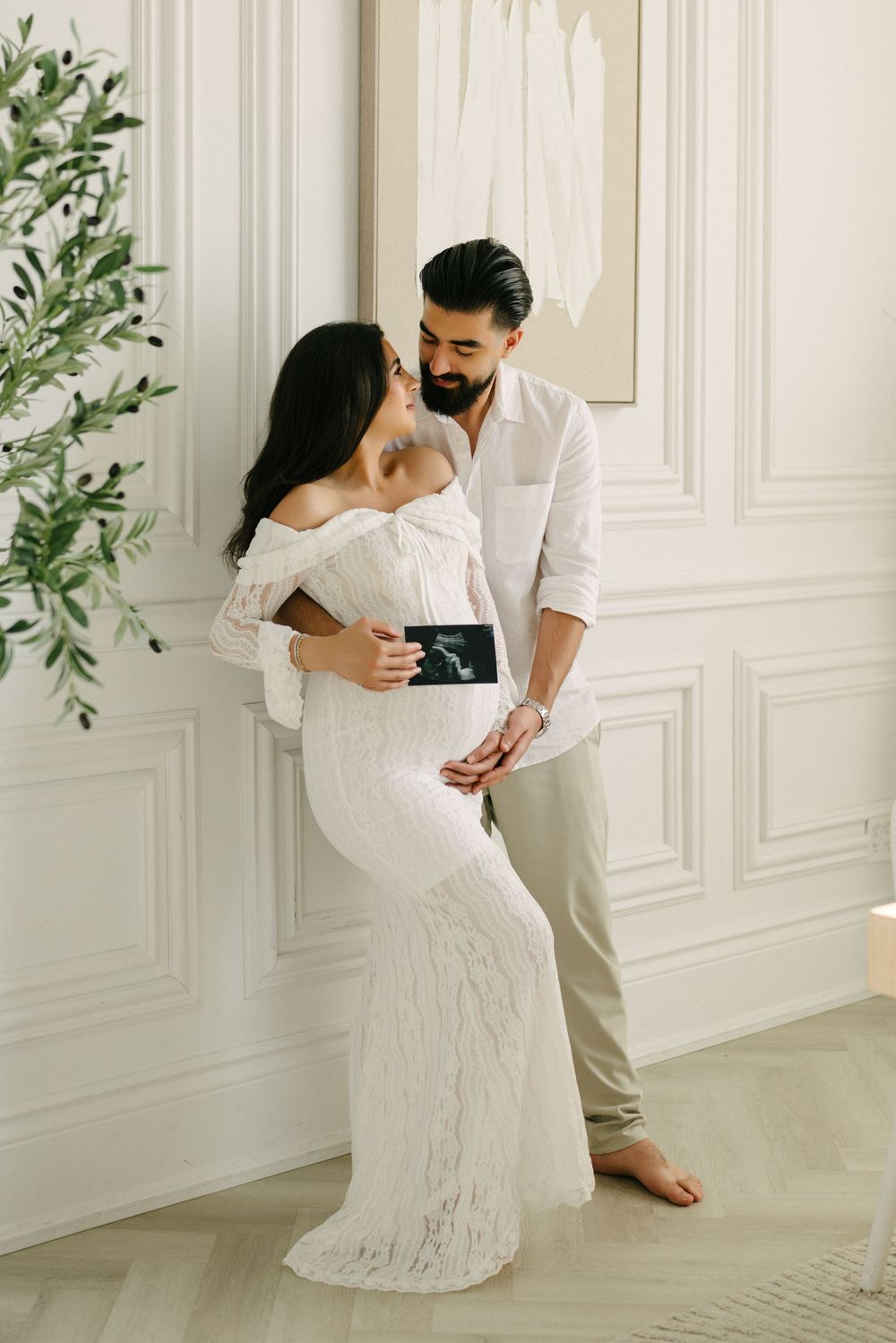 Expectant couple holding an ultrasound photo together.