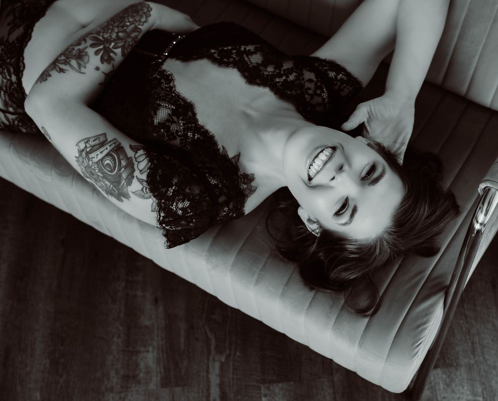 A series of black and white artistic boudoir portrait photographs showing someone lying down on a couch.
