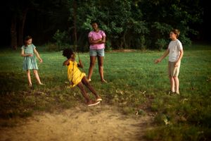 Memphis Family Photographer portrait of siblings playing at Shelby Farms during Golden Hour.
