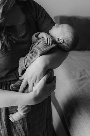 Five black and white images showing hands gently massaging a person's knee in different positions and angles.