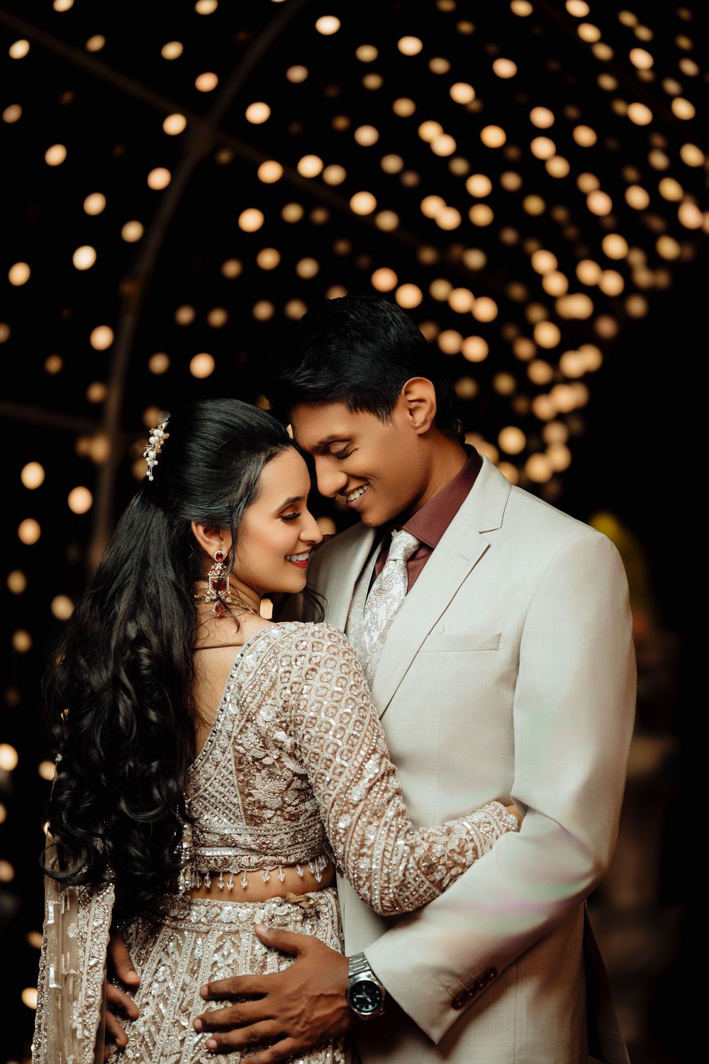 A romantic couple in wedding attire share intimate moments against a glowing bokeh light backdrop in multiple poses.