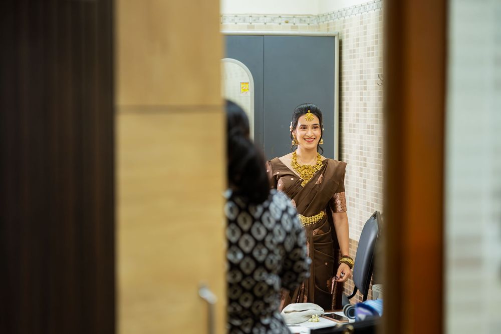 Three figures are visible through doorways having a casual conversation in what appears to be an office hallway.
