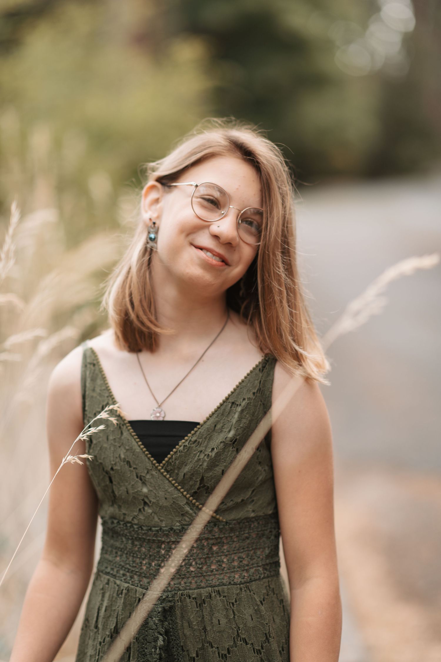 Preteen girl being shy at a family photo session in Spokane, Washington in the late summer.