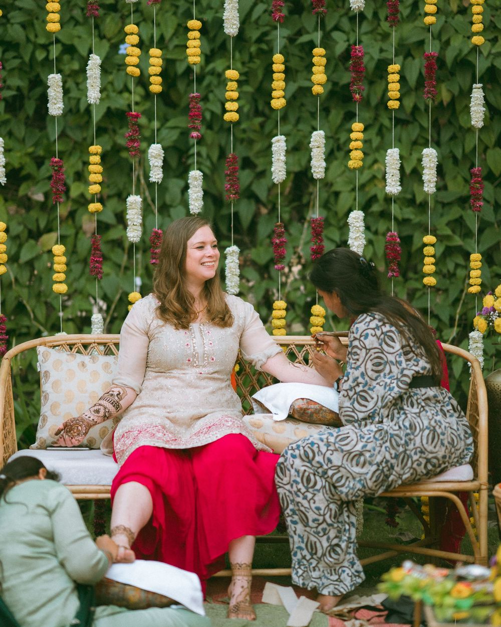Garden party setup with hanging decorations and comfortable seating arrangements.
