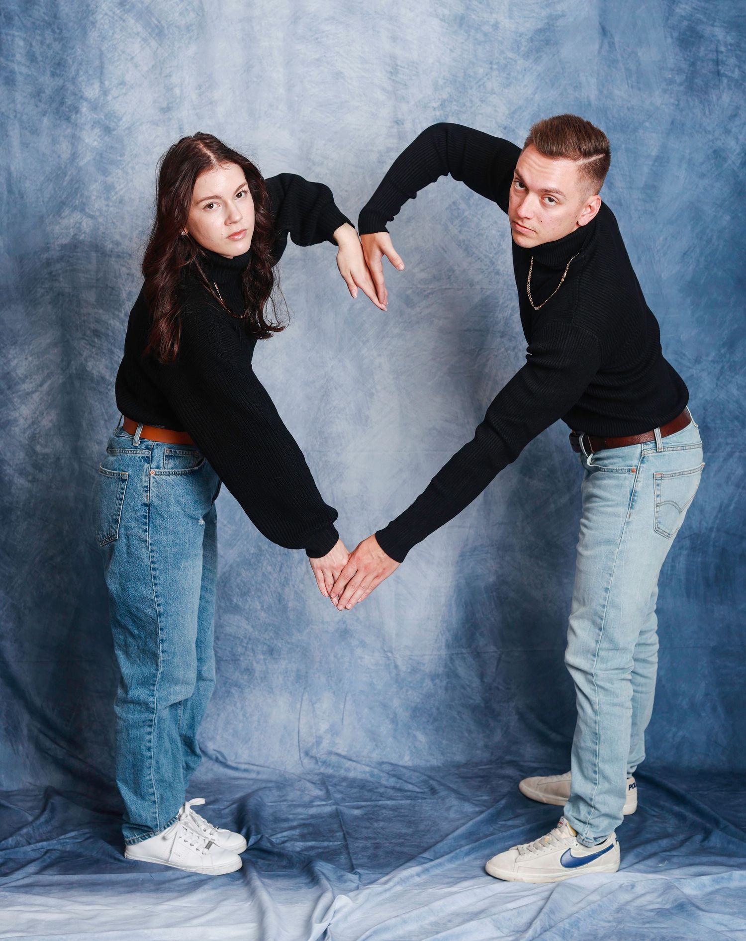 Step by step demonstration of dance partners performing a back dip move in casual jeans and black tops against blue wall.