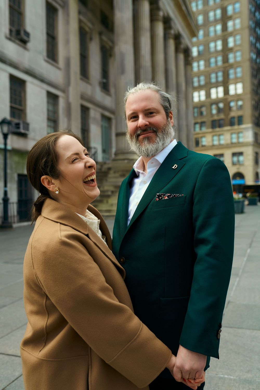 Four candid engagement photos showing a happy couple in formal attire laughing together outside a historic building.  Wedding photography