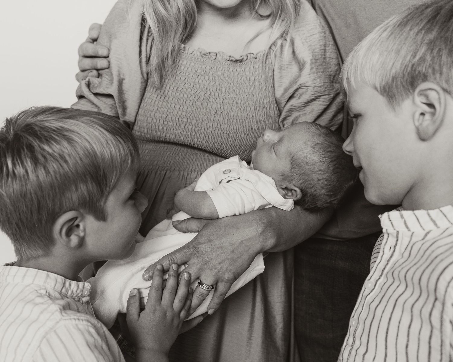 black and white intimate moments between family during studio photoshoot