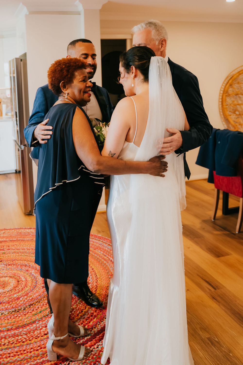 A series of three heartwarming moments showing an emotional first look reveal between loved ones at a wedding.