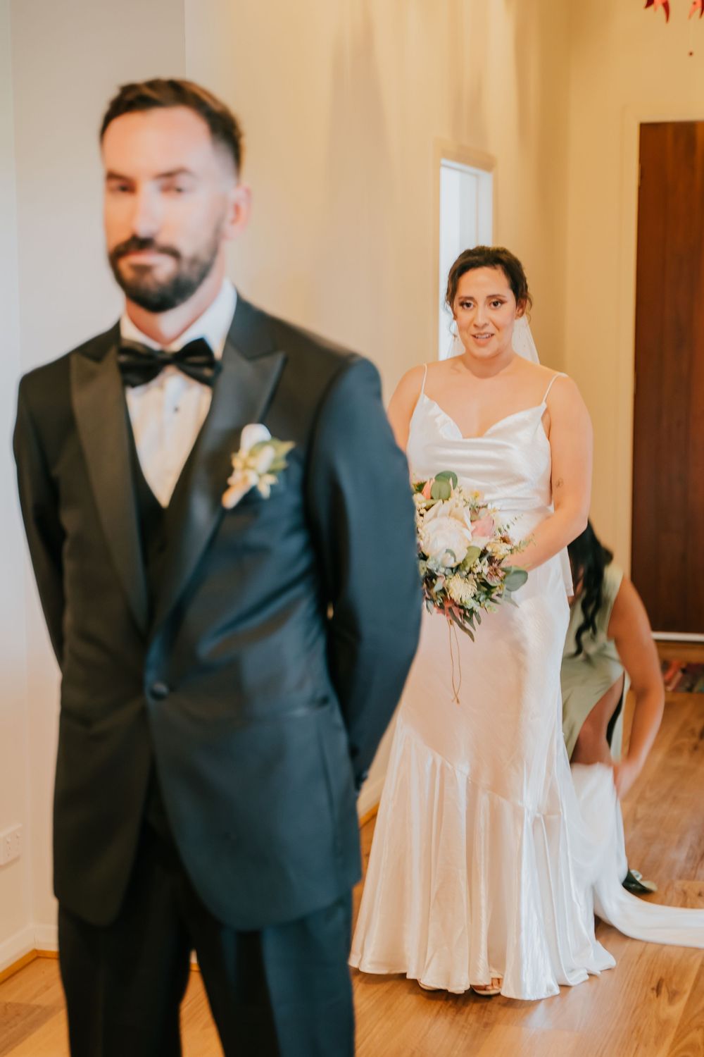 A series of candid wedding photos showing a couple in formal attire laughing and interacting in an indoor venue.