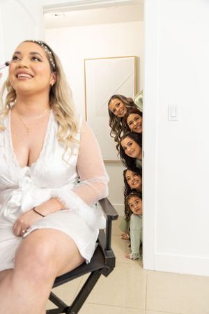 A collection of candid bathroom mirror photos showing people in white clothing posing together and individually.
