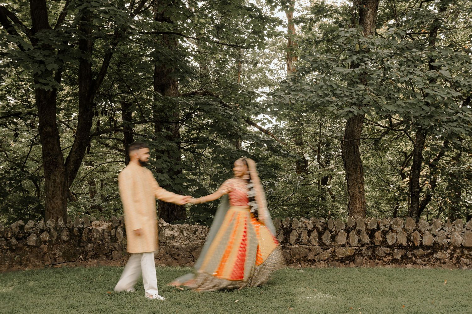 Pakistani wedding couple holding hands during sunset photoshoot