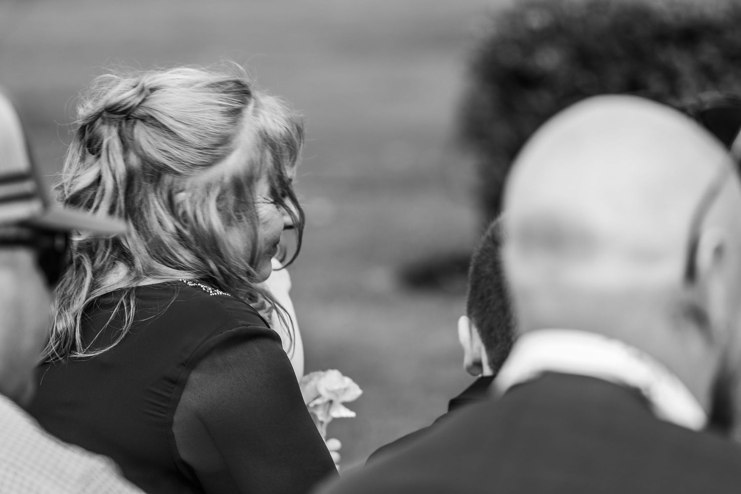 Black and white candid moment captured during an emotional wedding ceremony.