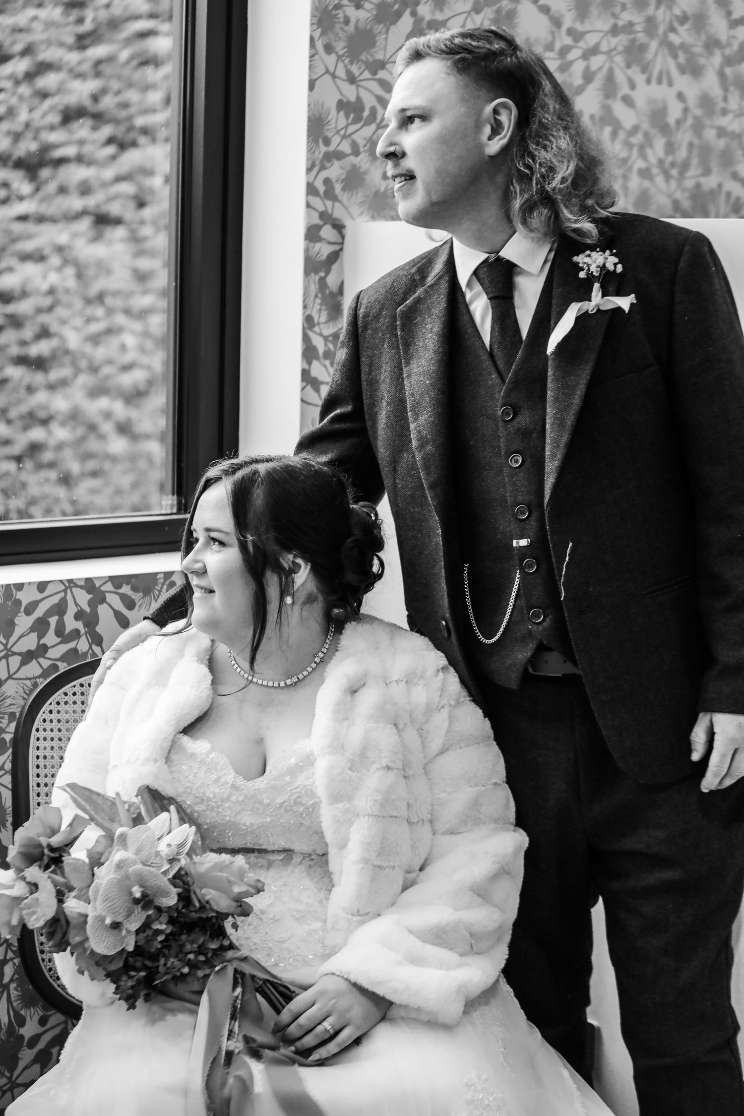 A couple shares intimate moments in vintage-inspired wedding attire.