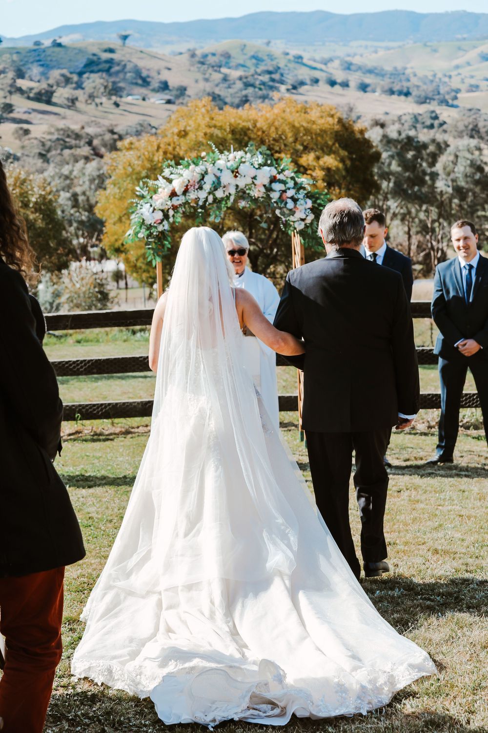 A series of scenic outdoor wedding ceremony photos showing rolling hills and mountains in the background with group gatherings.