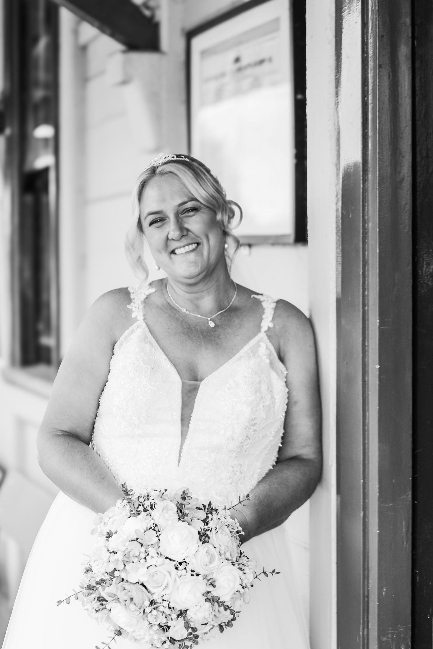 Elegant bridal portraits showing a white wedding dress and floral bouquet.