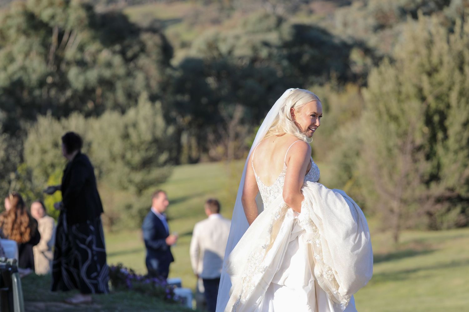 Outdoor wedding ceremony taking place in a scenic mountain landscape.