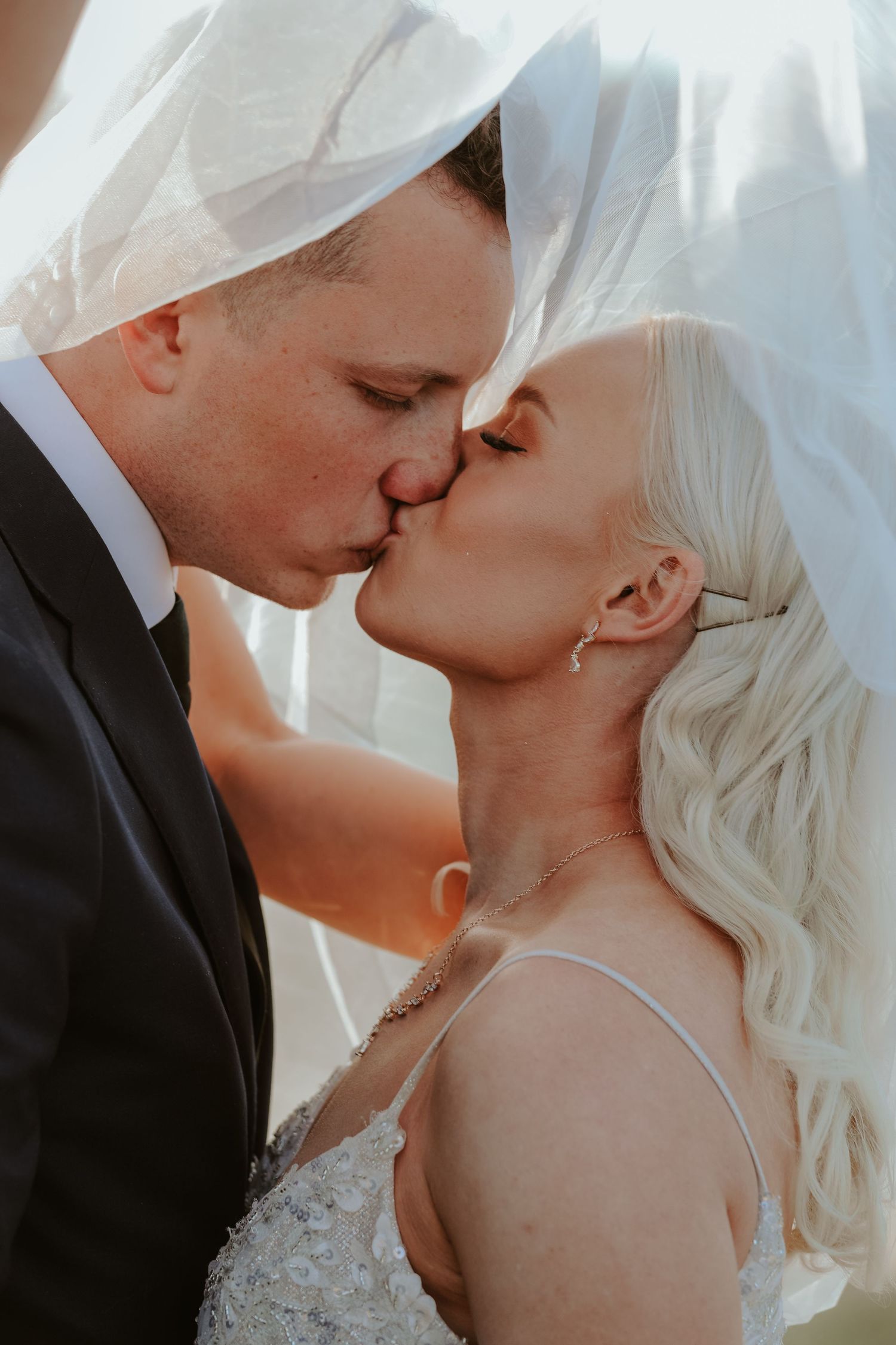 Intimate close-up wedding photography sequence showing tender moments between newlyweds.