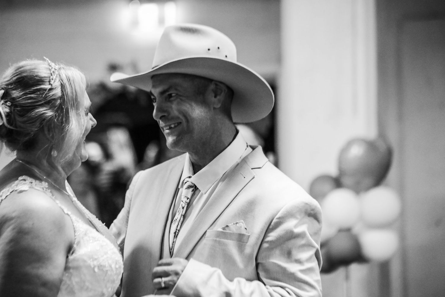 Wedding reception in black and white showing guests celebrating in a joyful atmosphere.