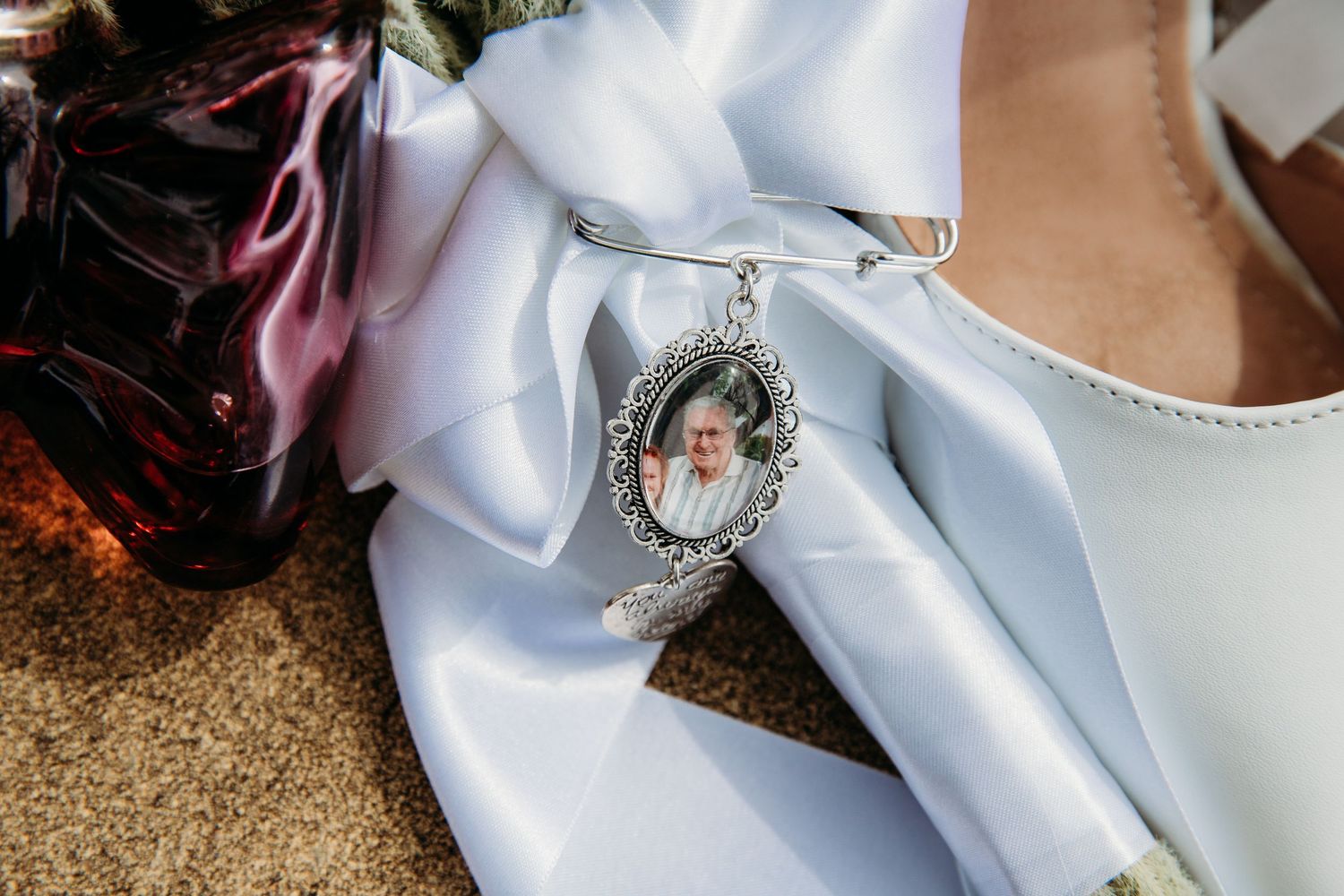 White satin wedding bow details with crystal embellishments and romantic decorative elements.