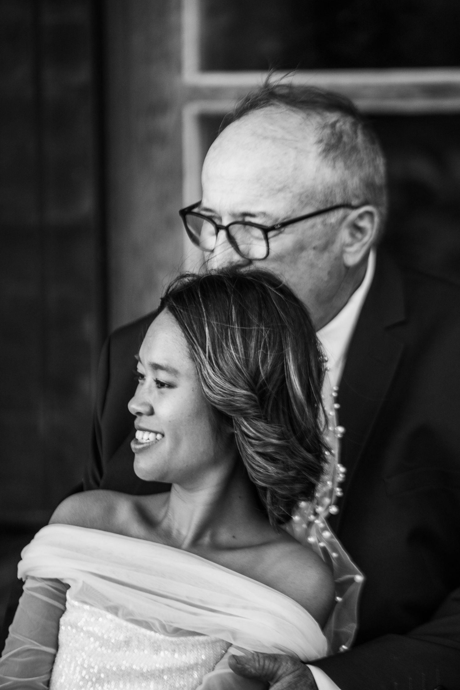 Black and white portrait showing tender moments between a couple on their wedding day.