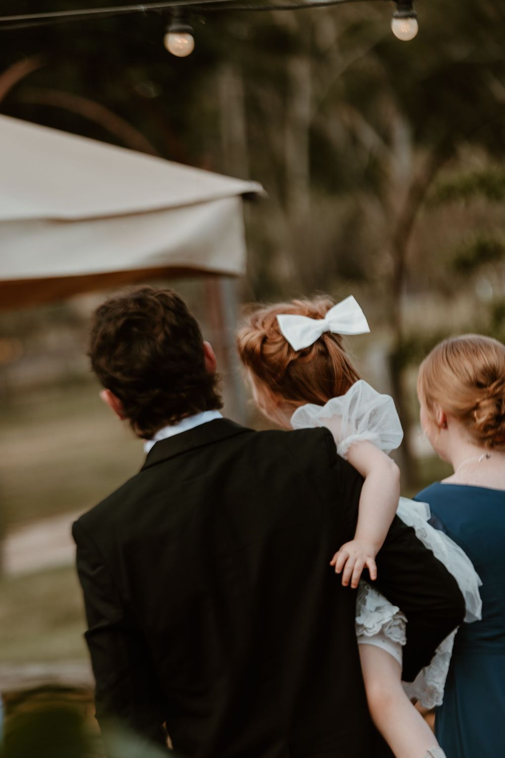 Moody evening reception photos showing couples dancing under string lights.