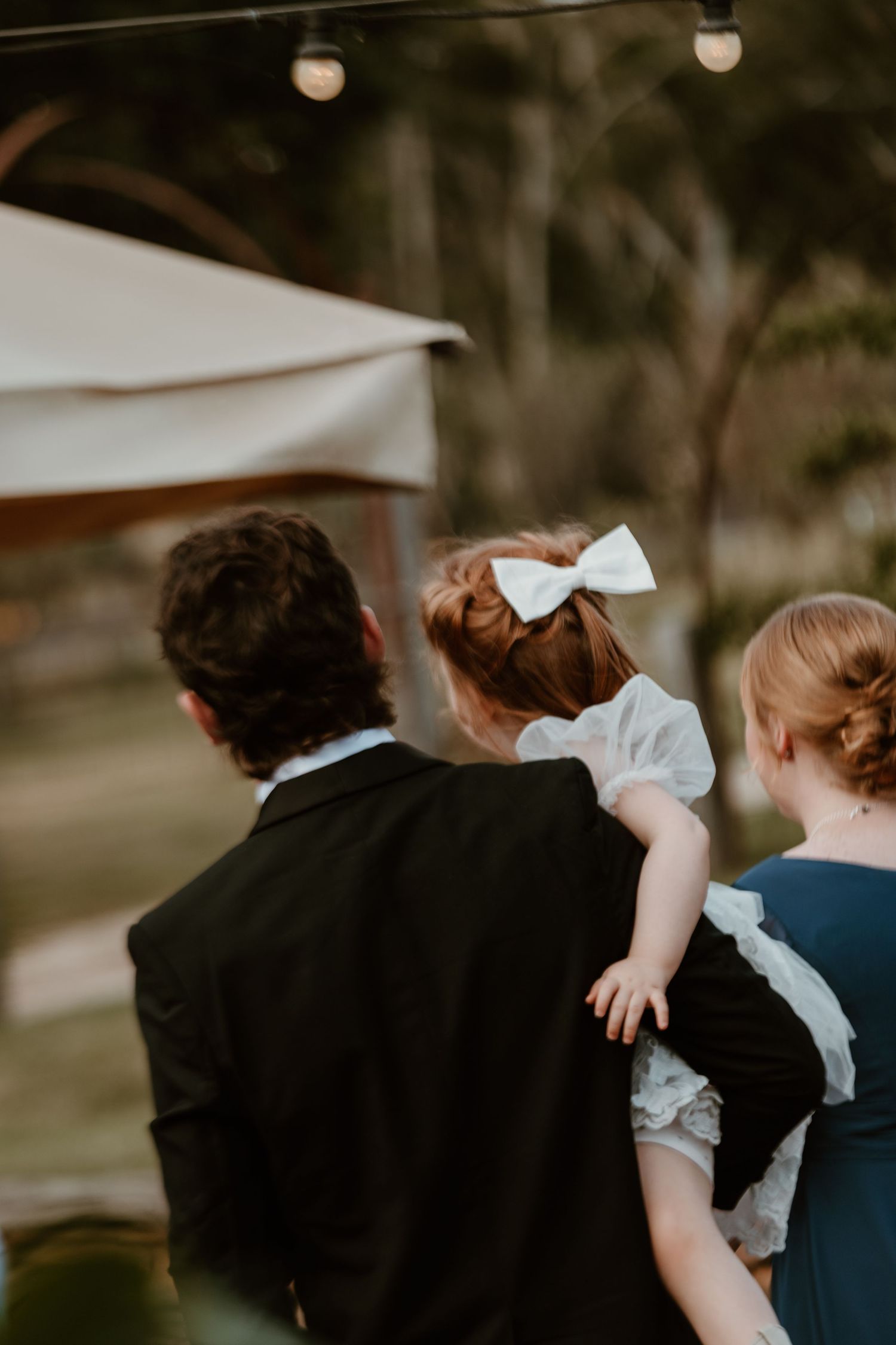 Moody evening reception photos showing couples dancing under string lights.