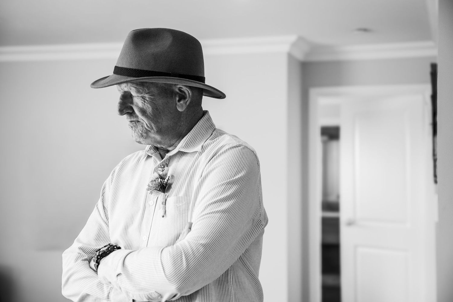 Candid black and white wedding photos showing emotional moments indoors with natural window light.