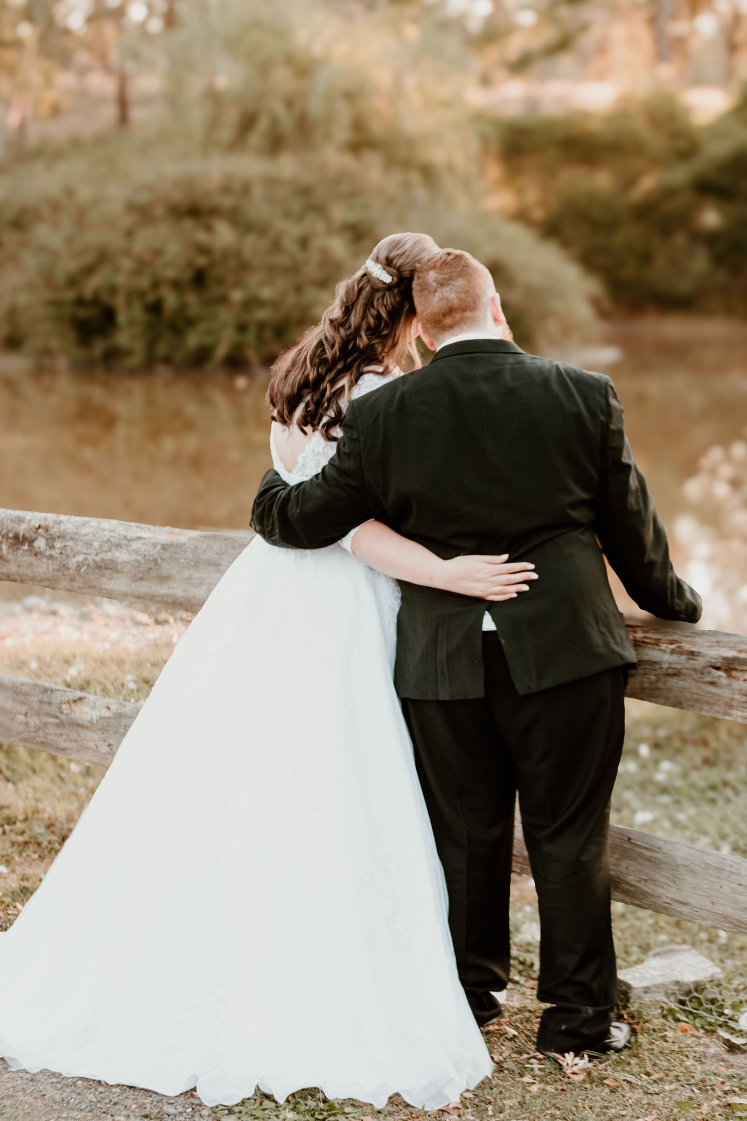 Wedding couple shares emotional moments together in an outdoor garden setting.