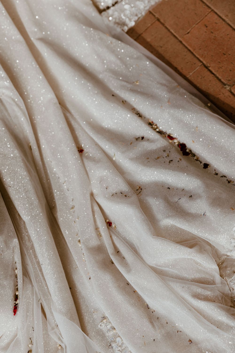Detailed texture of a sparkly white wedding dress fabric.