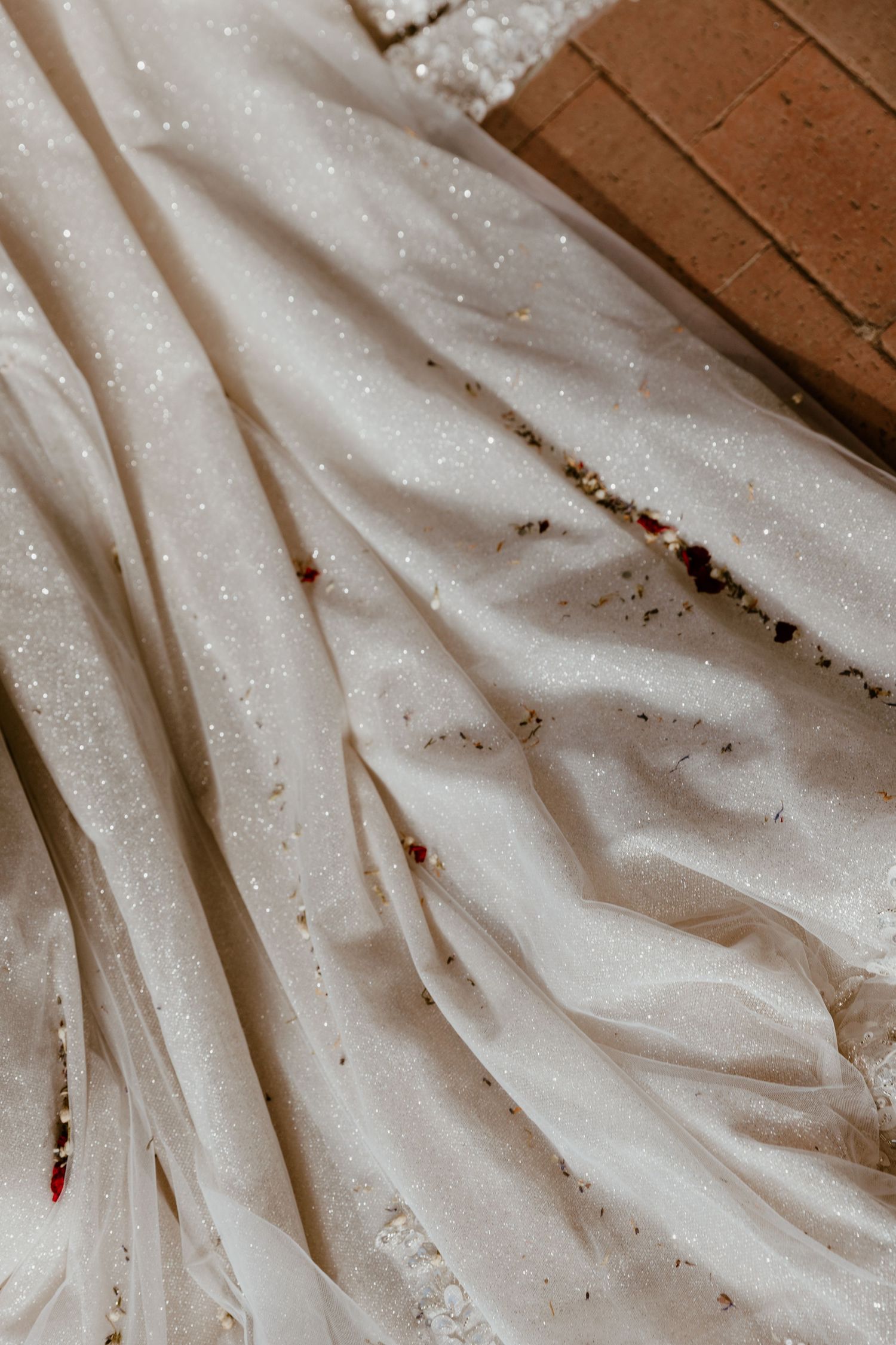 Detailed texture of a sparkly white wedding dress fabric.