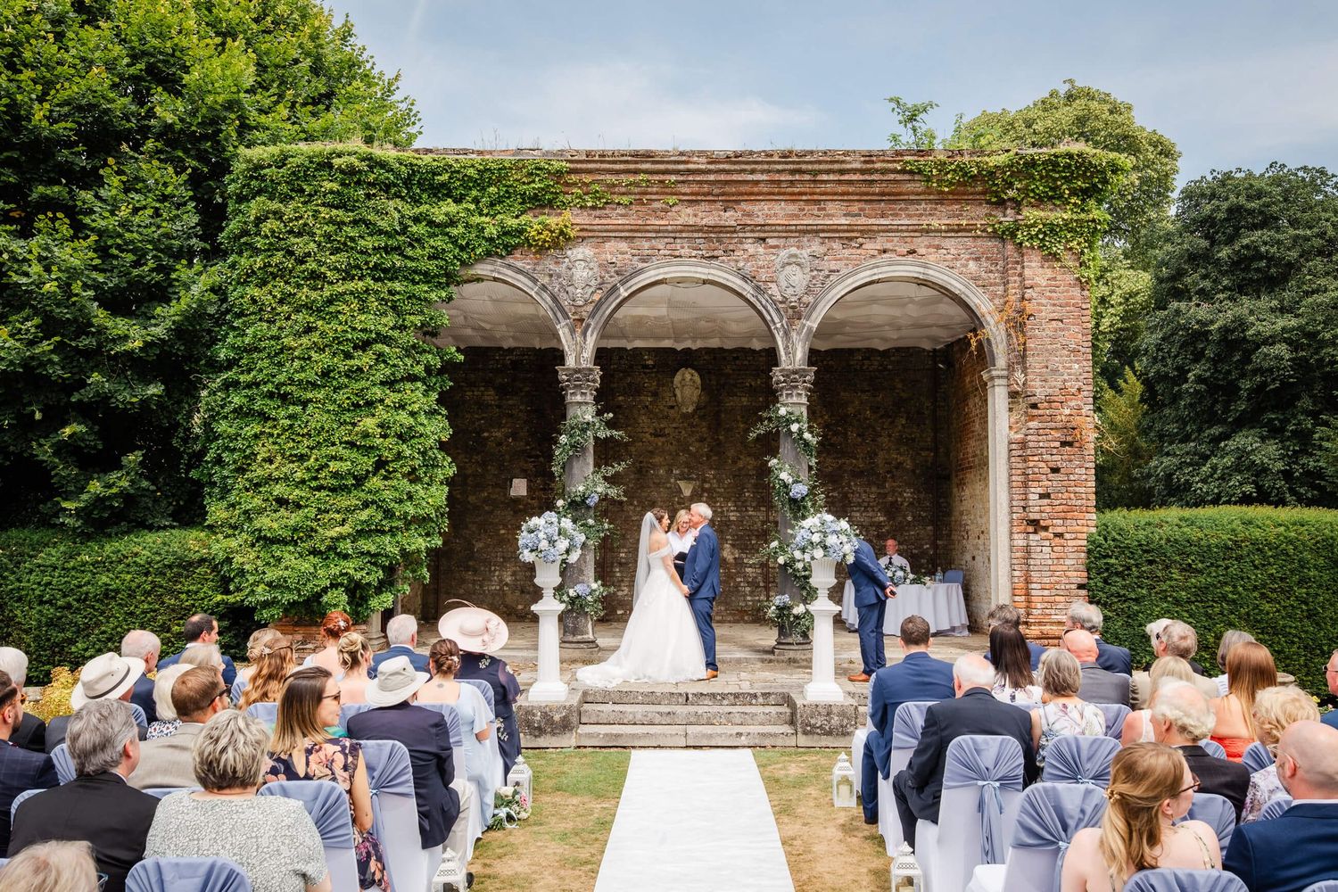 Wedding ceremony at Broome Park Hotel in Kent Bride and groom in the Loggia