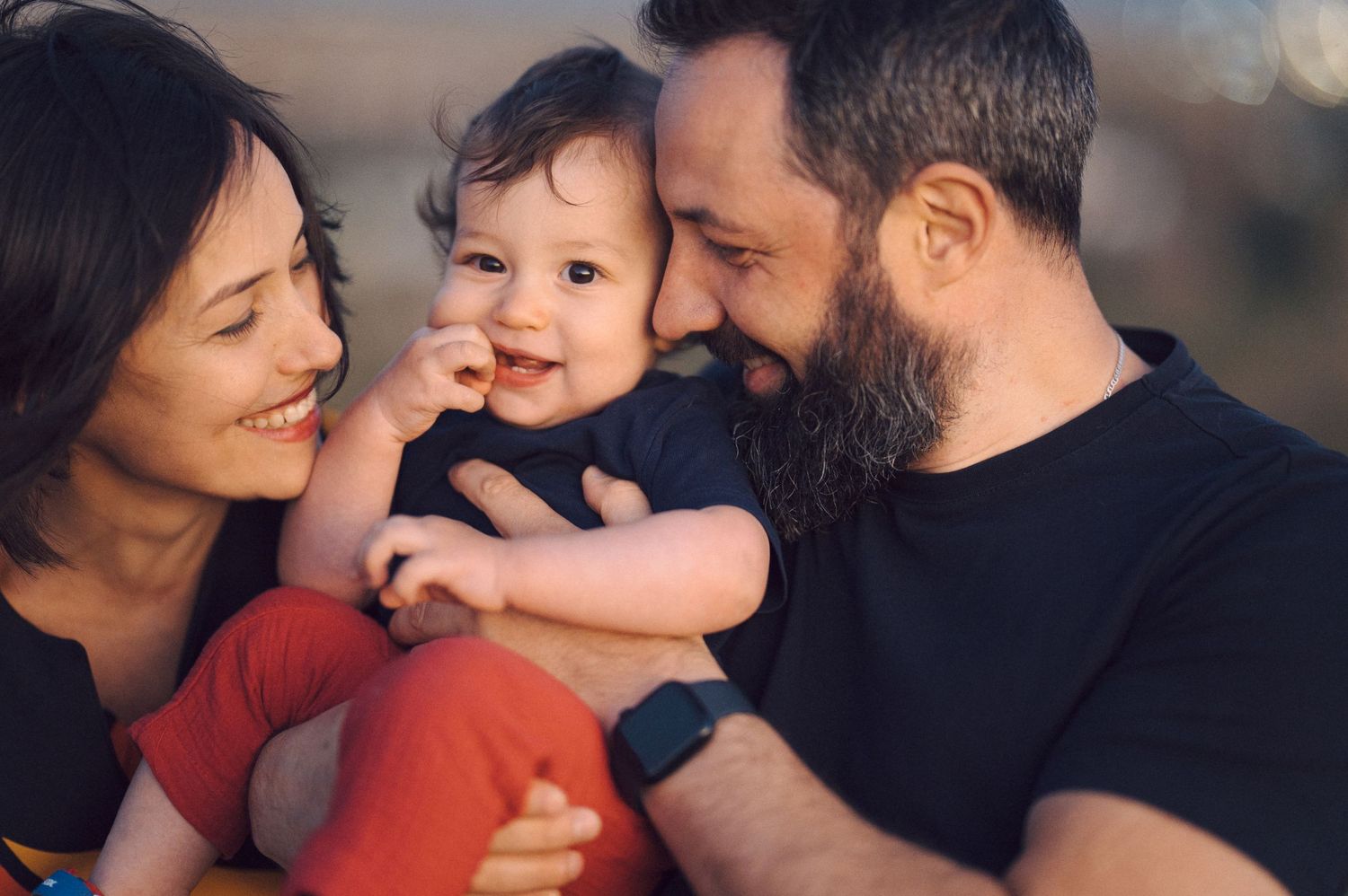 A loving family moment captured during golden hour outdoors.