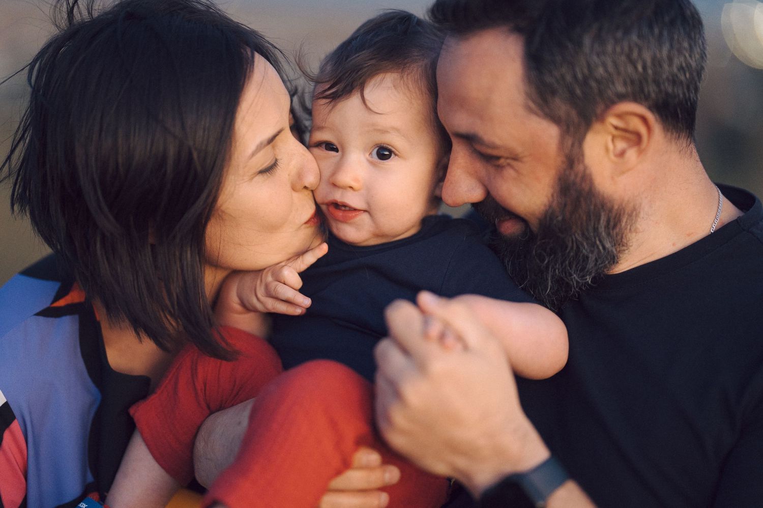 An intimate family portrait filled with joy and laughter at sunset.
