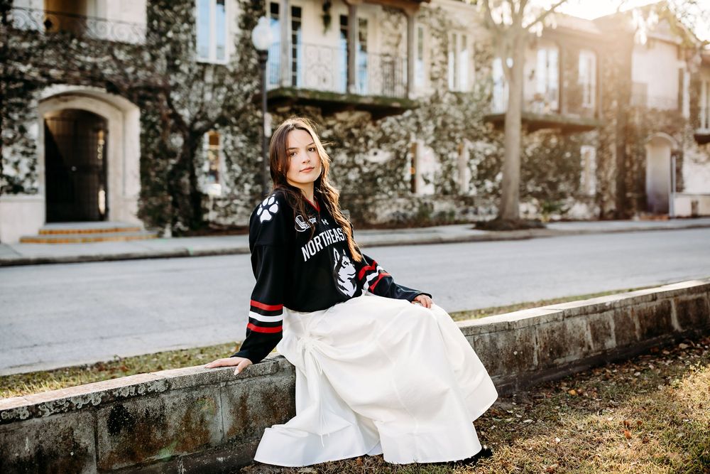 Candid bridal portrait session in warm sunlight against vintage building facade creates romantic ambiance.