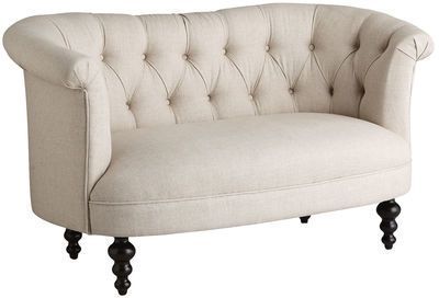 Cream-colored tufted upholstered loveseat sofa with turned wooden legs and elegant button details shown from multiple angles.