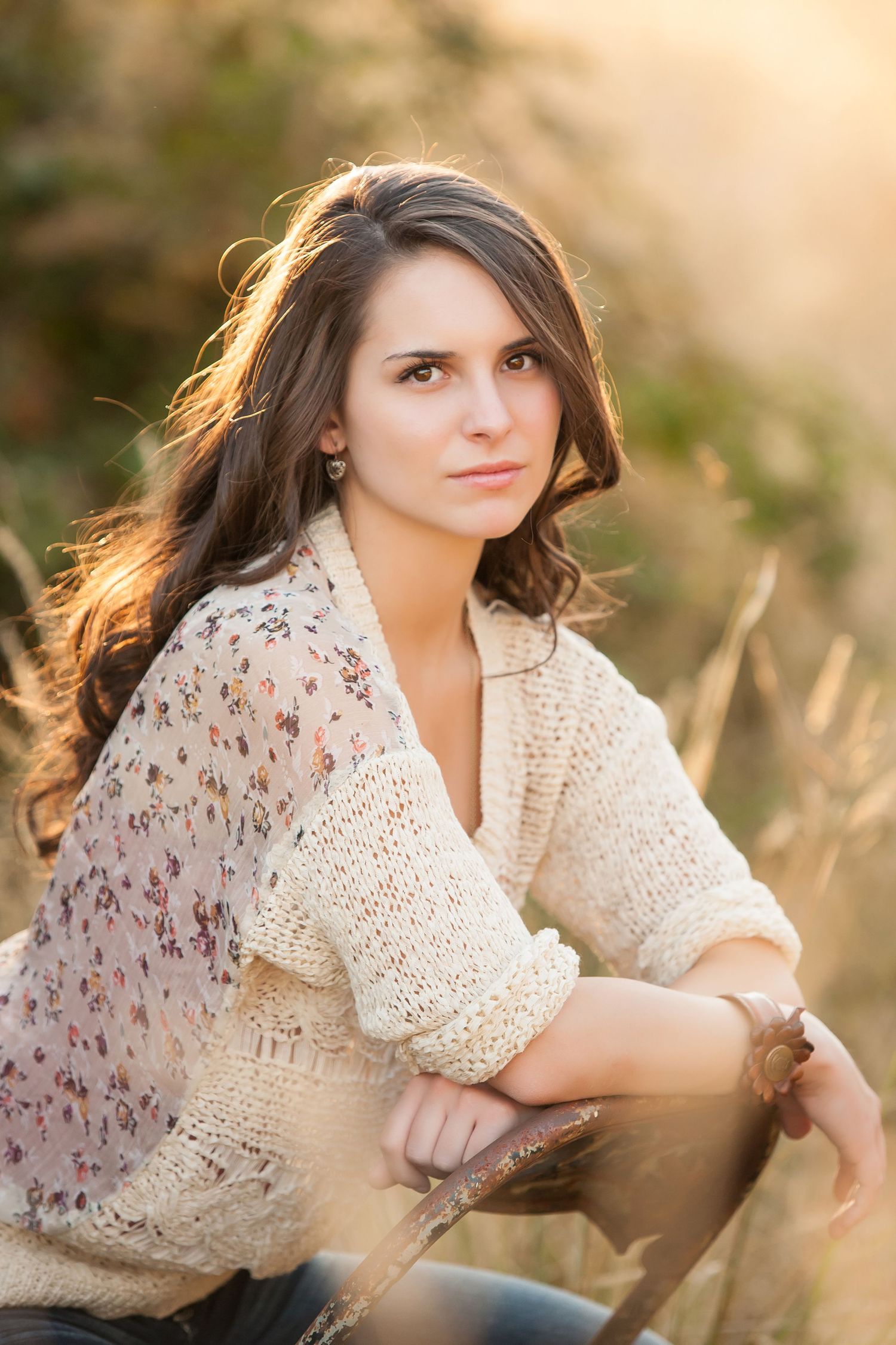 High School senior girl posing on a rock