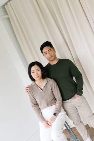 Four minimalist portrait photos showing a couple posing together against a white curtain backdrop.
