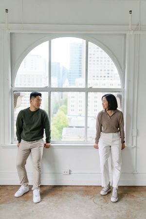 Series of abstract figures in casual attire performing sequential dance movements in a bright white studio space.