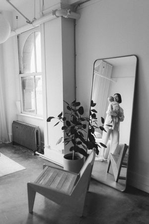 Five black and white photos capture a figure practicing ballet positions against a bright minimalist white interior space.