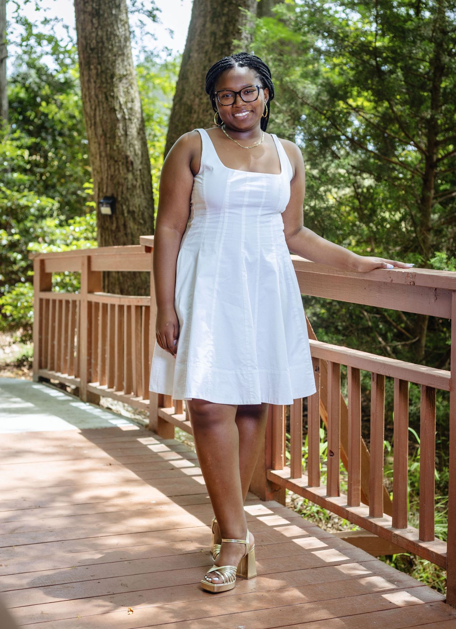 Summer fashion photos on a wooden deck featuring a white sundress and casual poses.