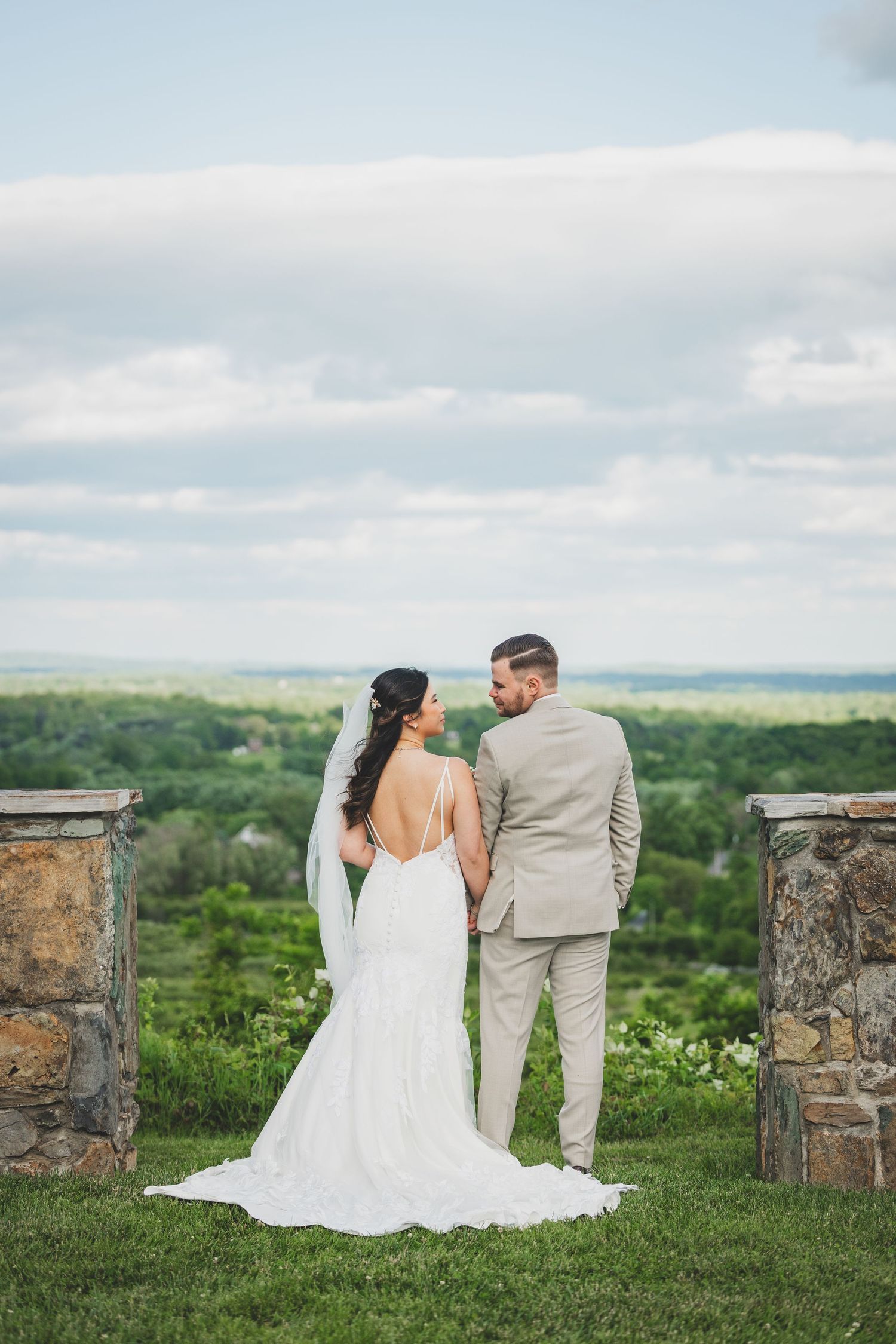 Newlywed couple shares intimate moment overlooking from the bluemont vineyard in virginia.