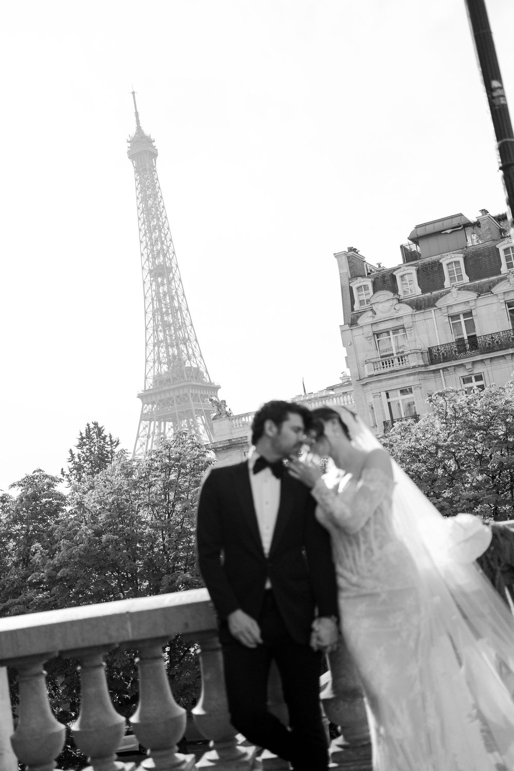 A romantic wedding photoshoot sequence showing a couple posing with the Eiffel Tower visible in the background.